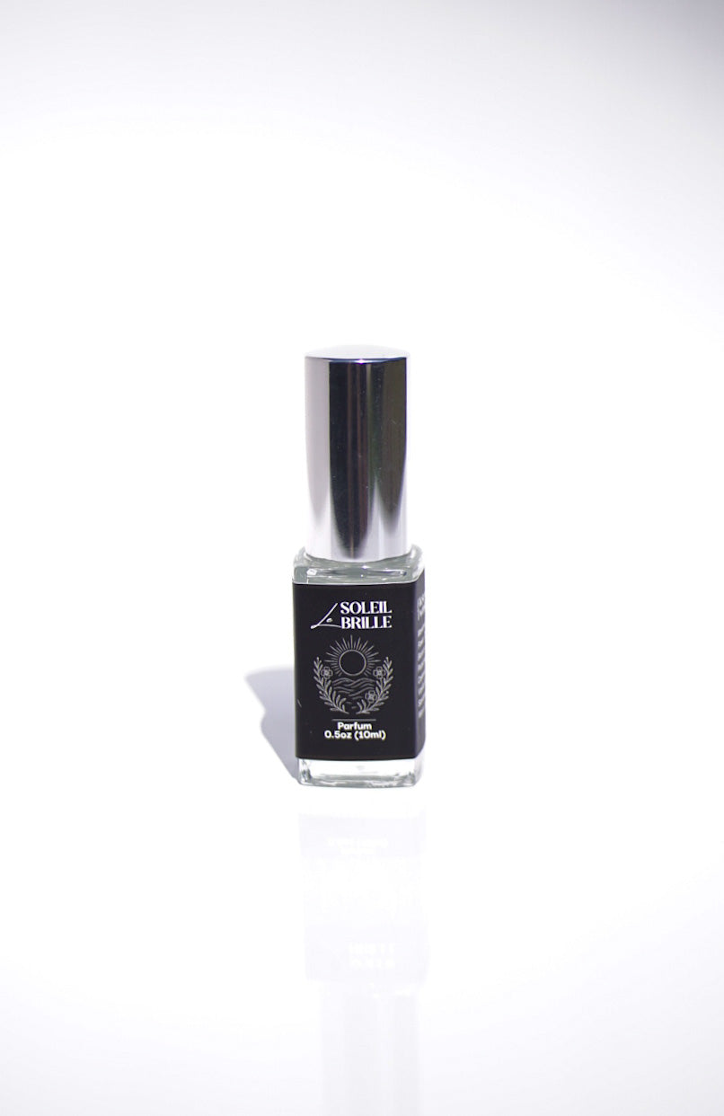 Small le soleil brille perfume bottle with a black label on a white background
