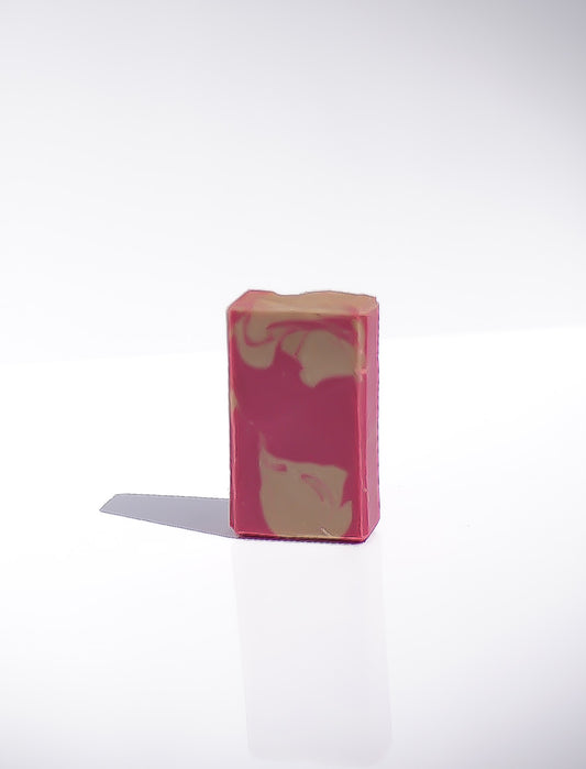 Small  4oz pink soap with a cream colored swirl pattern on a white background
