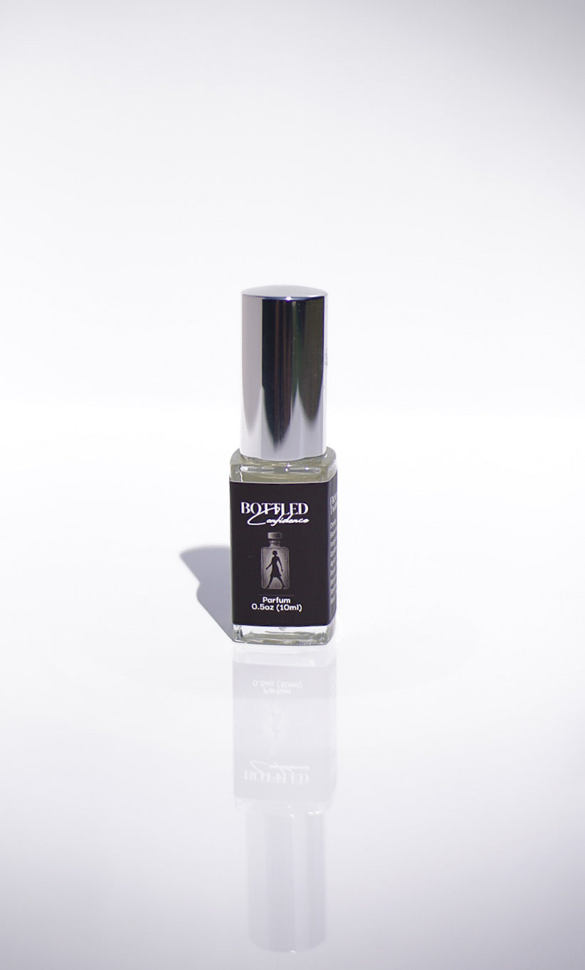 Small perfume bottle with a silver cap on a white background