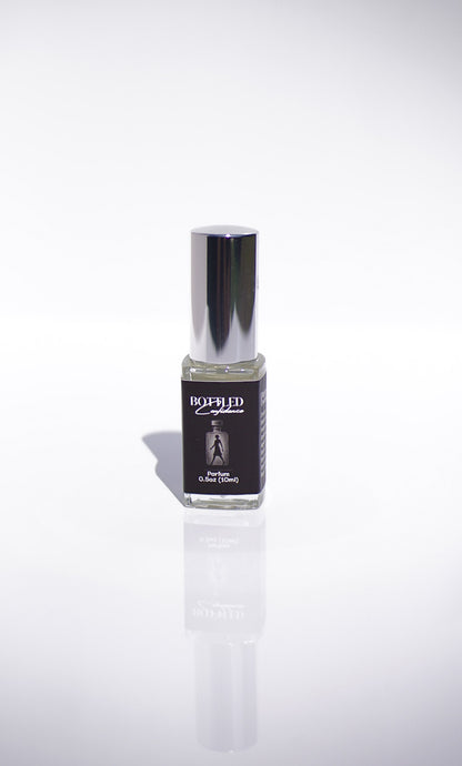 Small perfume bottle with a silver cap on a white background
