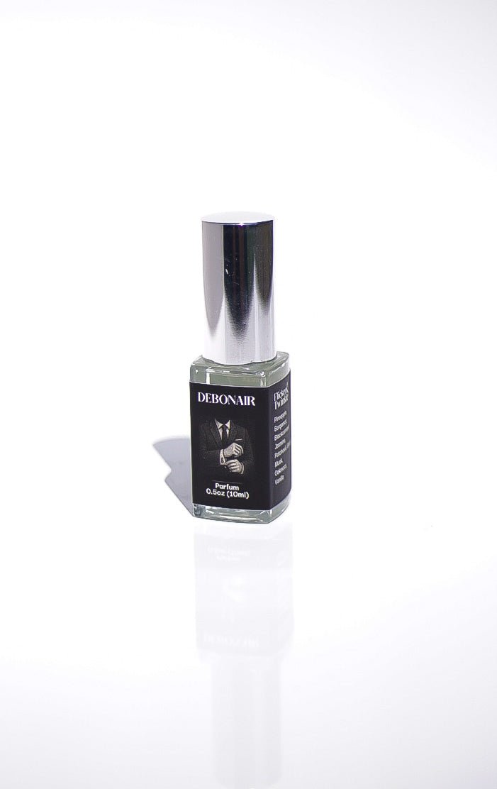 A small bottle of Debonair Parfum with a silver cap on a white background.