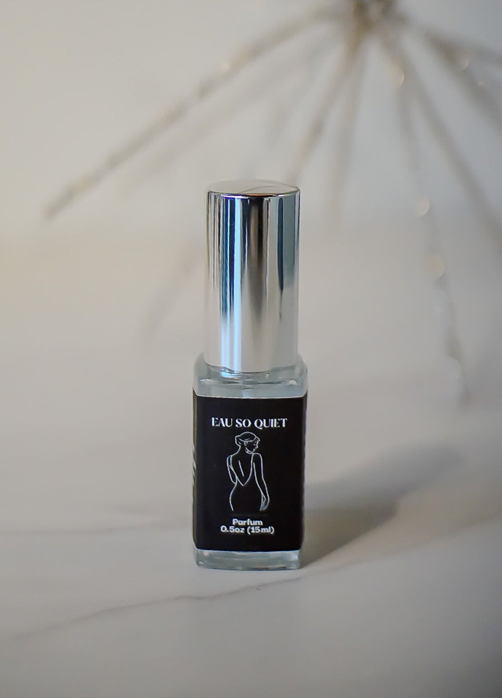 15mL Perfume bottle with black label featuring a silhouette on a white background