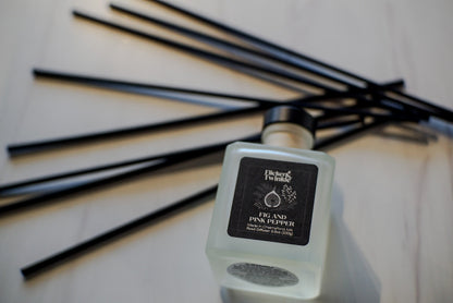 Fig and Pink Pepper Reed diffuser with black label on a light background with black reeds. 