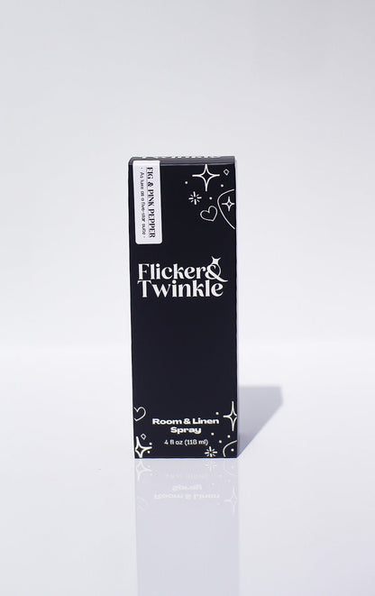 A black box with white text holds the Fig and Pink Peppercorn Room Spray, Mediterranean-inspired.