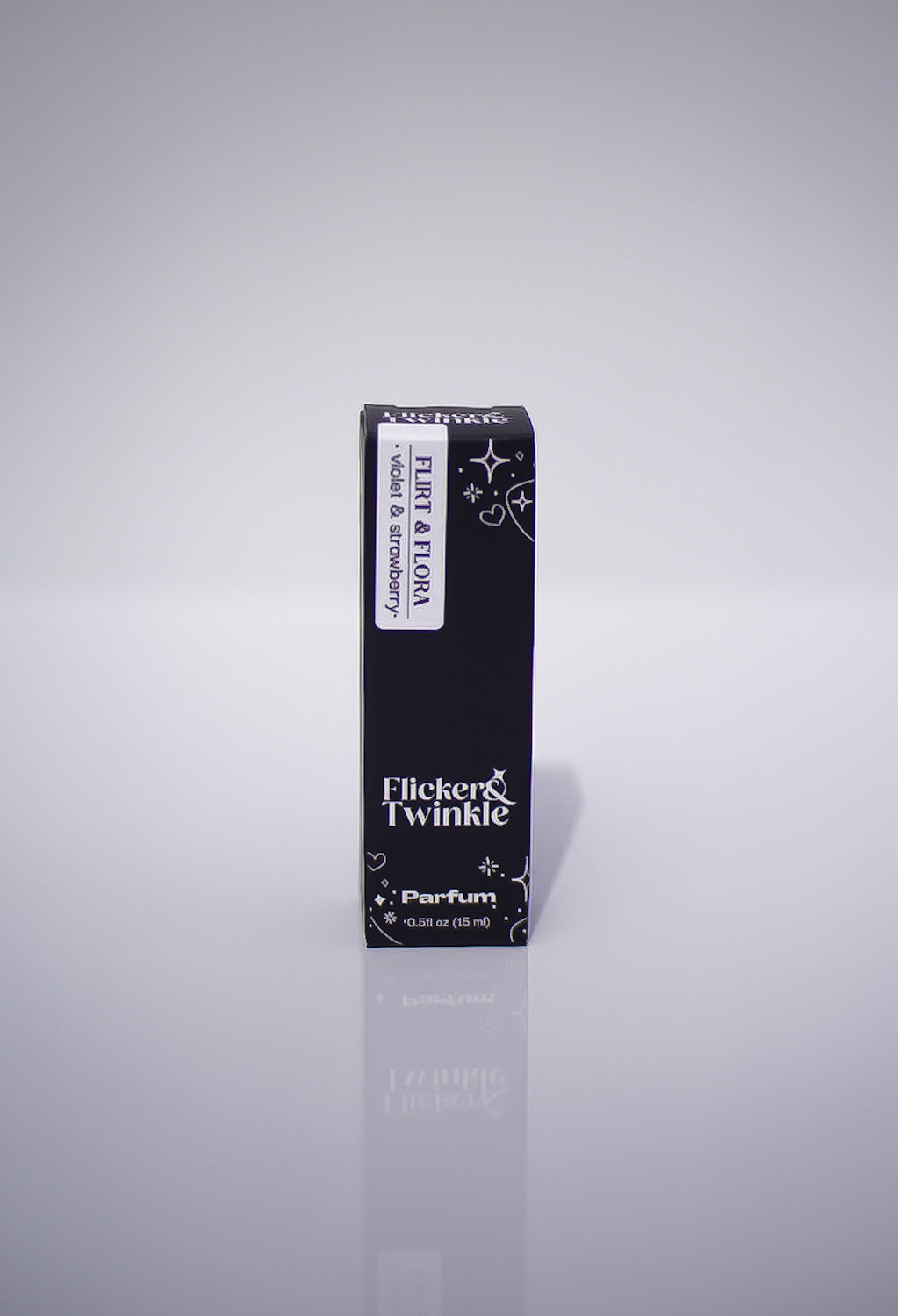 Black perfume box labeled 'Flicker & Twinkle' on a gray background