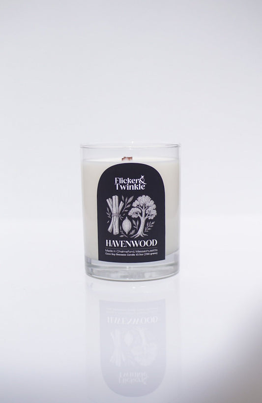 A luxury Havenwood Candle - Coconut Soy Beeswax in a glass jar by Flicker & Twinkle.