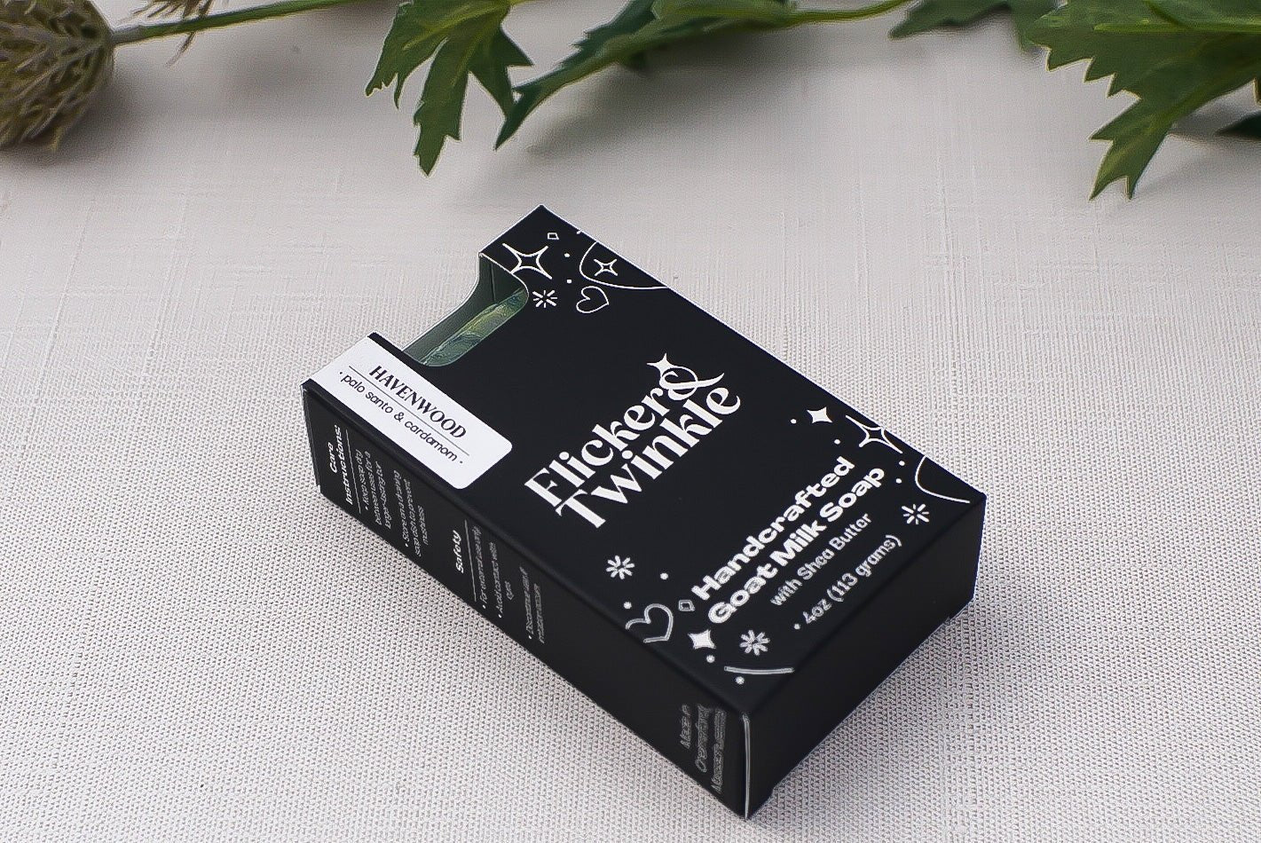 A black box of Havenwood Goat Milk Soap rests on a light fabric surface.