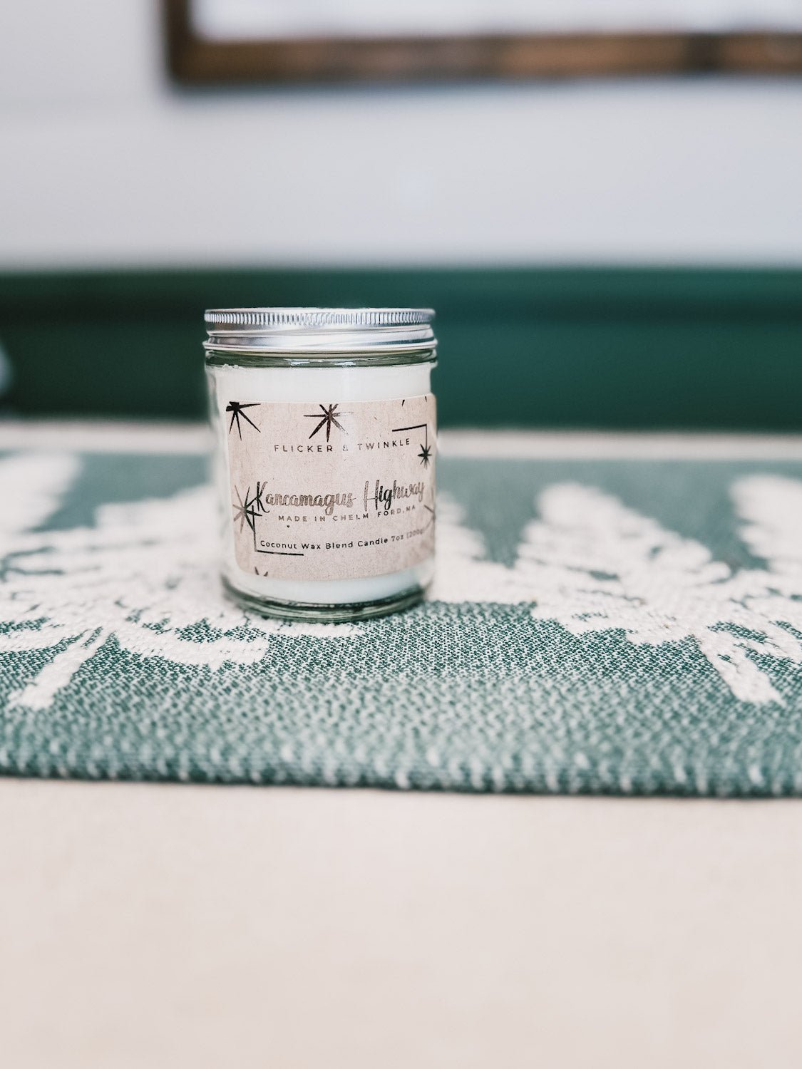 Kancamagus Highway on top of a green tree decorated runner on a beige table top