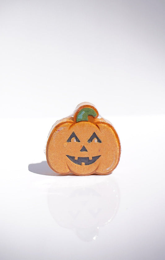 Jack-O-Lantern Bath Bomb: an orange pumpkin with a carved face, perfect for bath time fun.