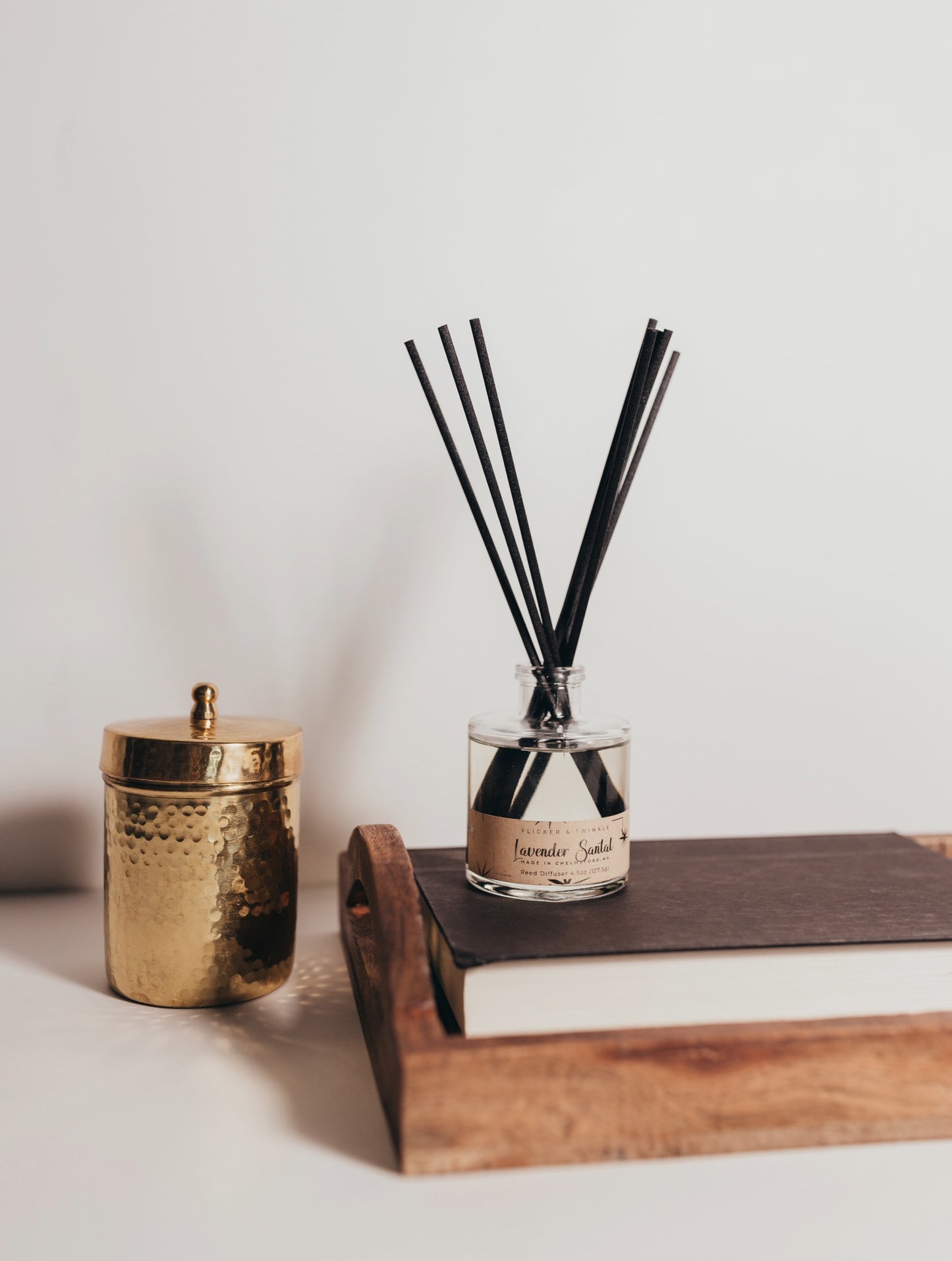 Lavender Santal reed diffuser with 8 black fiber reeds, essential and fragrance oils in a sleek clear bottle, perfect for aromatherapy and relaxation.