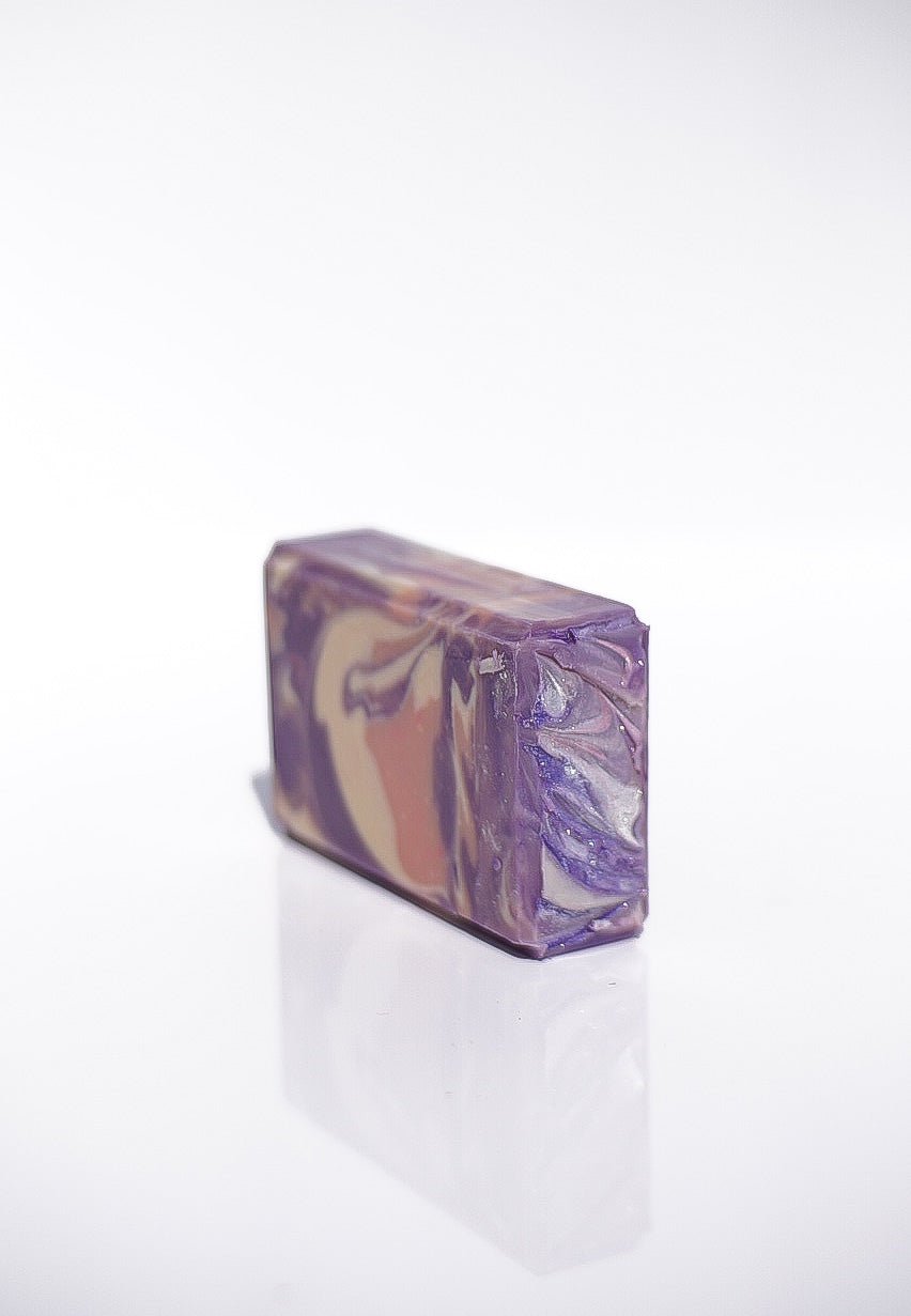 Lavender Santal Goats Milk Soap: a rectangular bar with purple, tan, and white swirls.