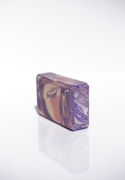 Lavender Santal Goats Milk Soap: a rectangular bar with purple, tan, and white swirls.