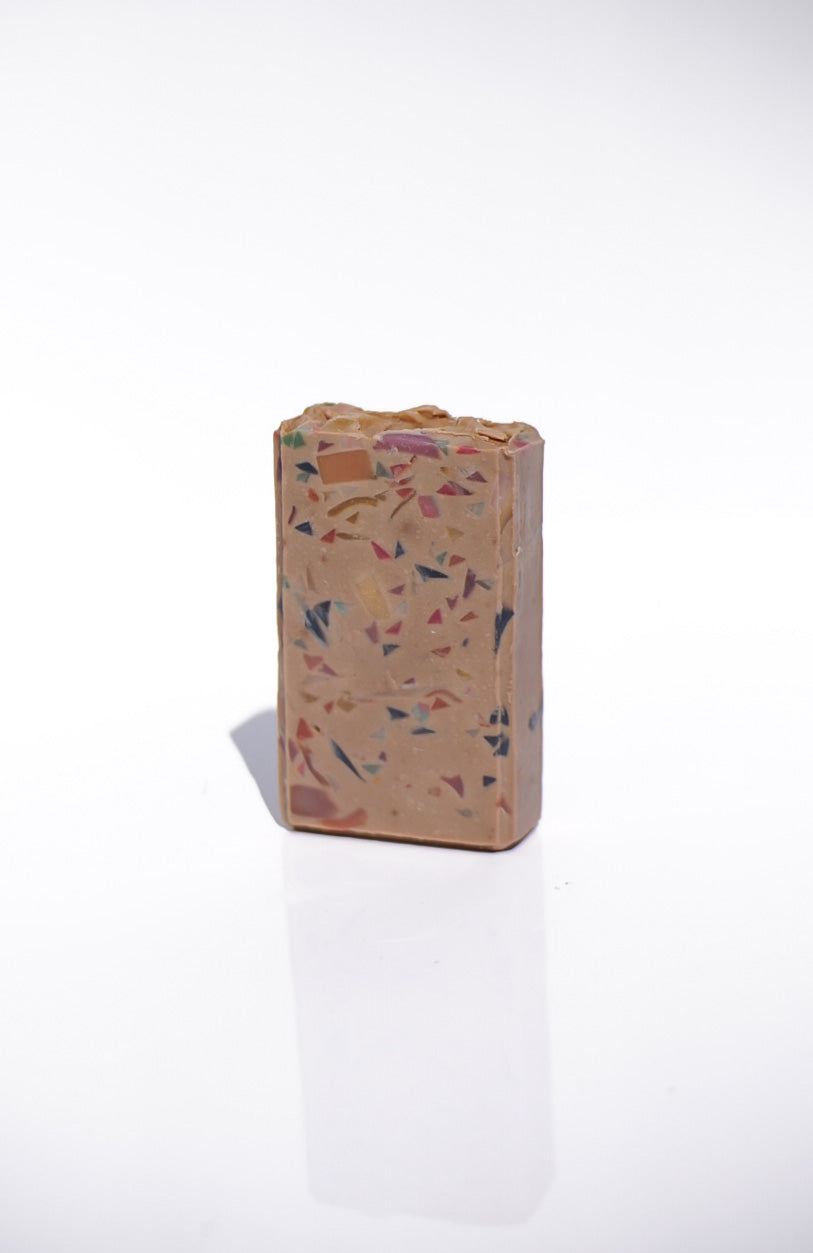 Rectangular terrazzo-style block on a white background Luxury goat milk soap—creamy lather with sandalwood & amber dry-down