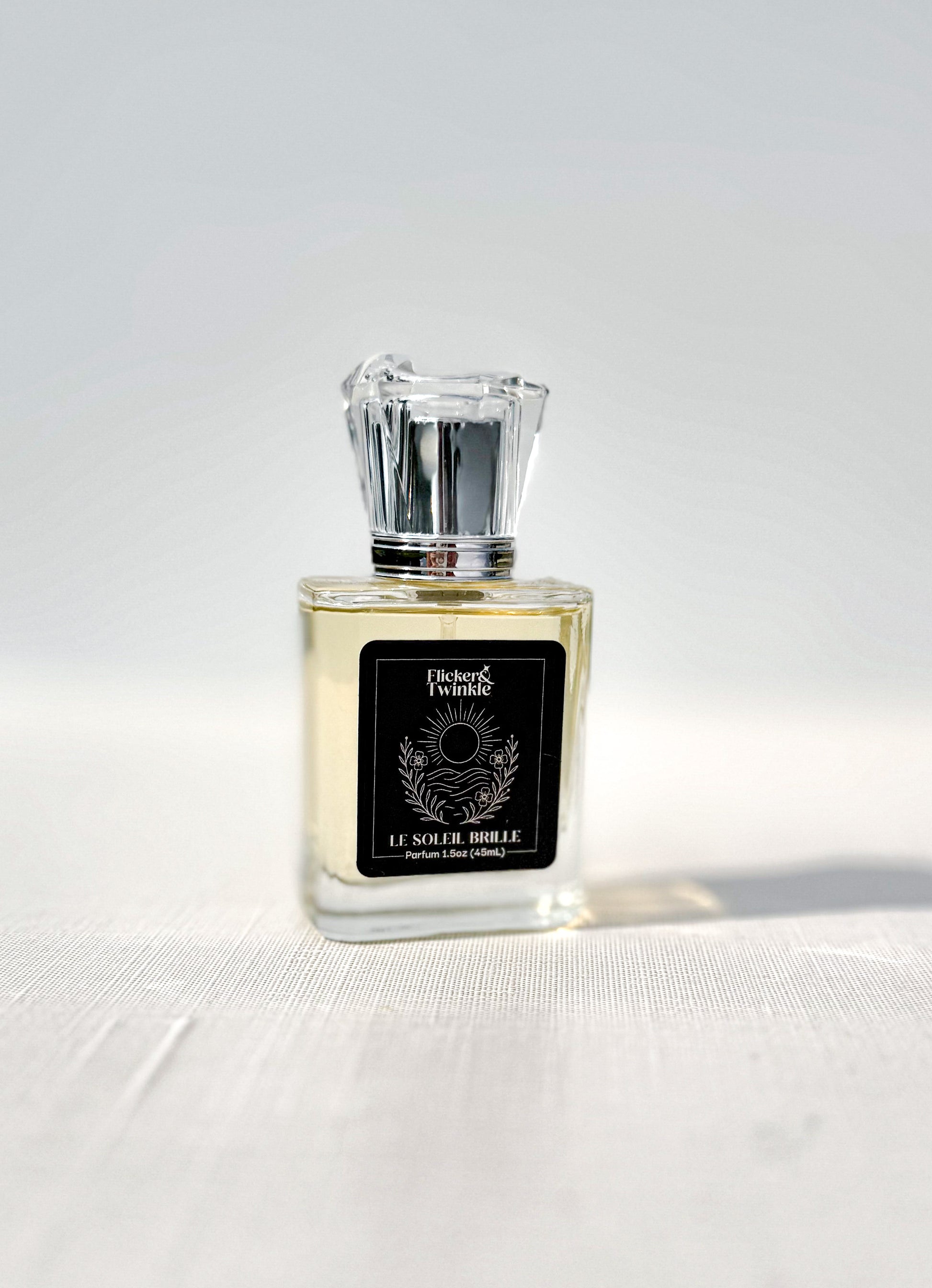 le Soleil Brille Perfume bottle with a black label on a white background