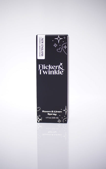 Black box labeled New England Room and Linen Spray with white designs and text.