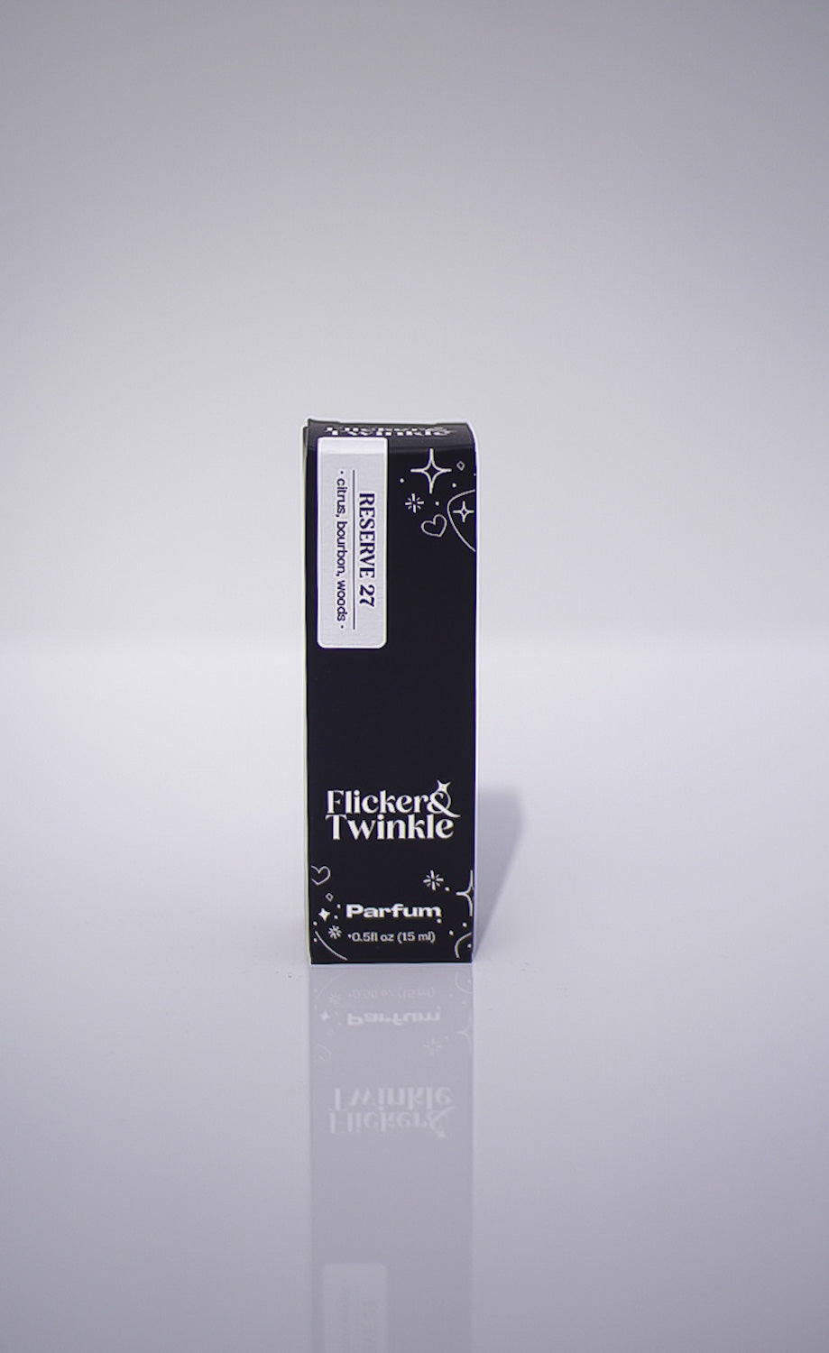 Black perfume bottle box with 'Flicker & Twinkle' branding on a gray background