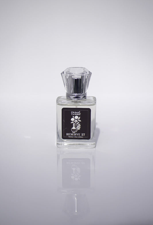 Perfume bottle labeled 'Reserve 27' on a reflective gray surface with a light gray background