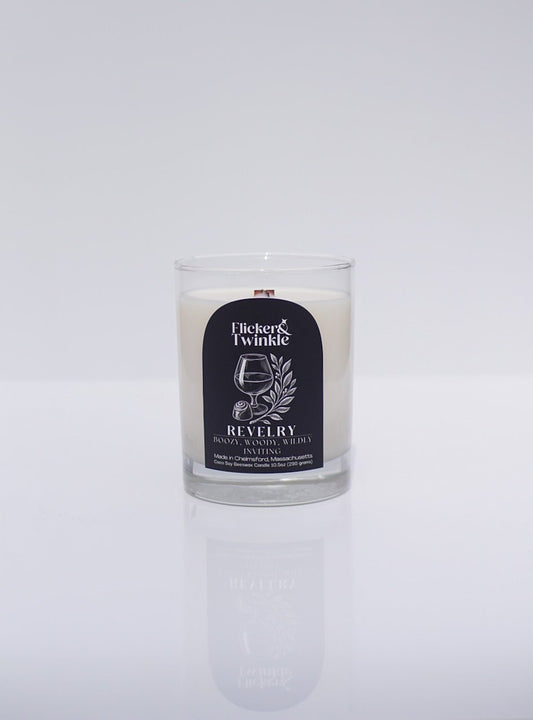 A luxury coconut wax candle in a glass jar labeled Revelry Coconut Wax Candle.