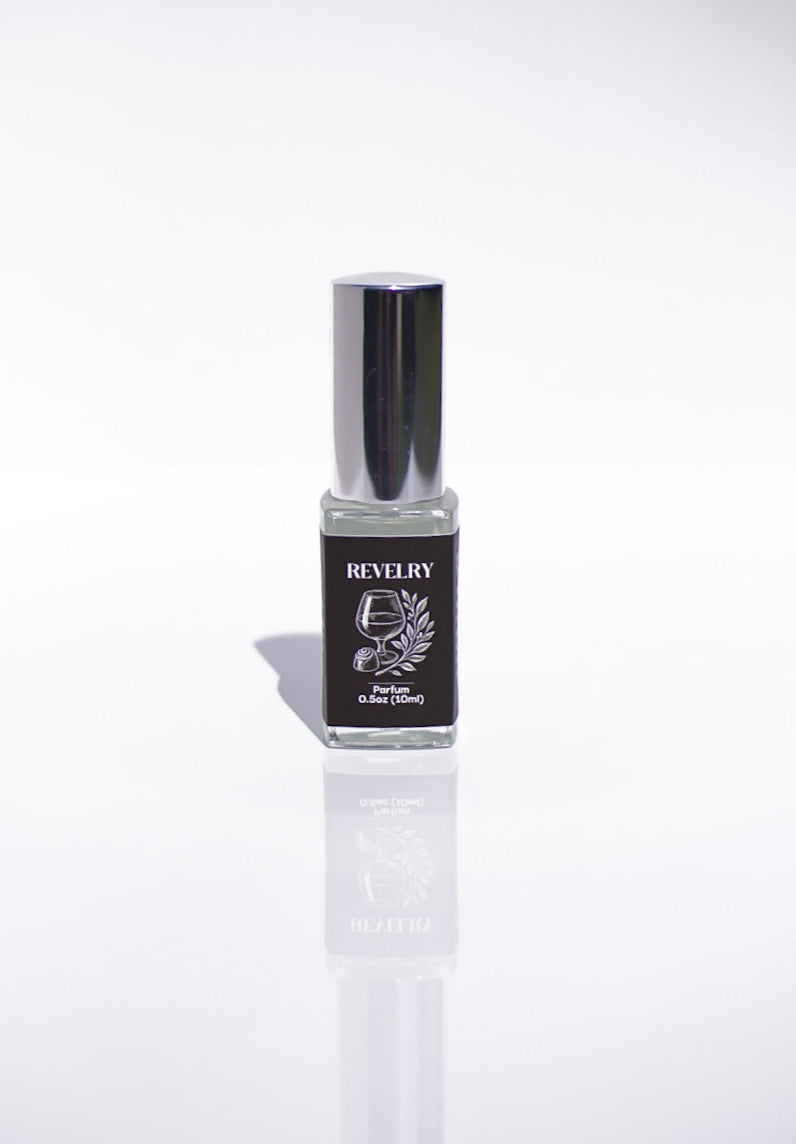 Small bottle of Revelry perfume on a white background