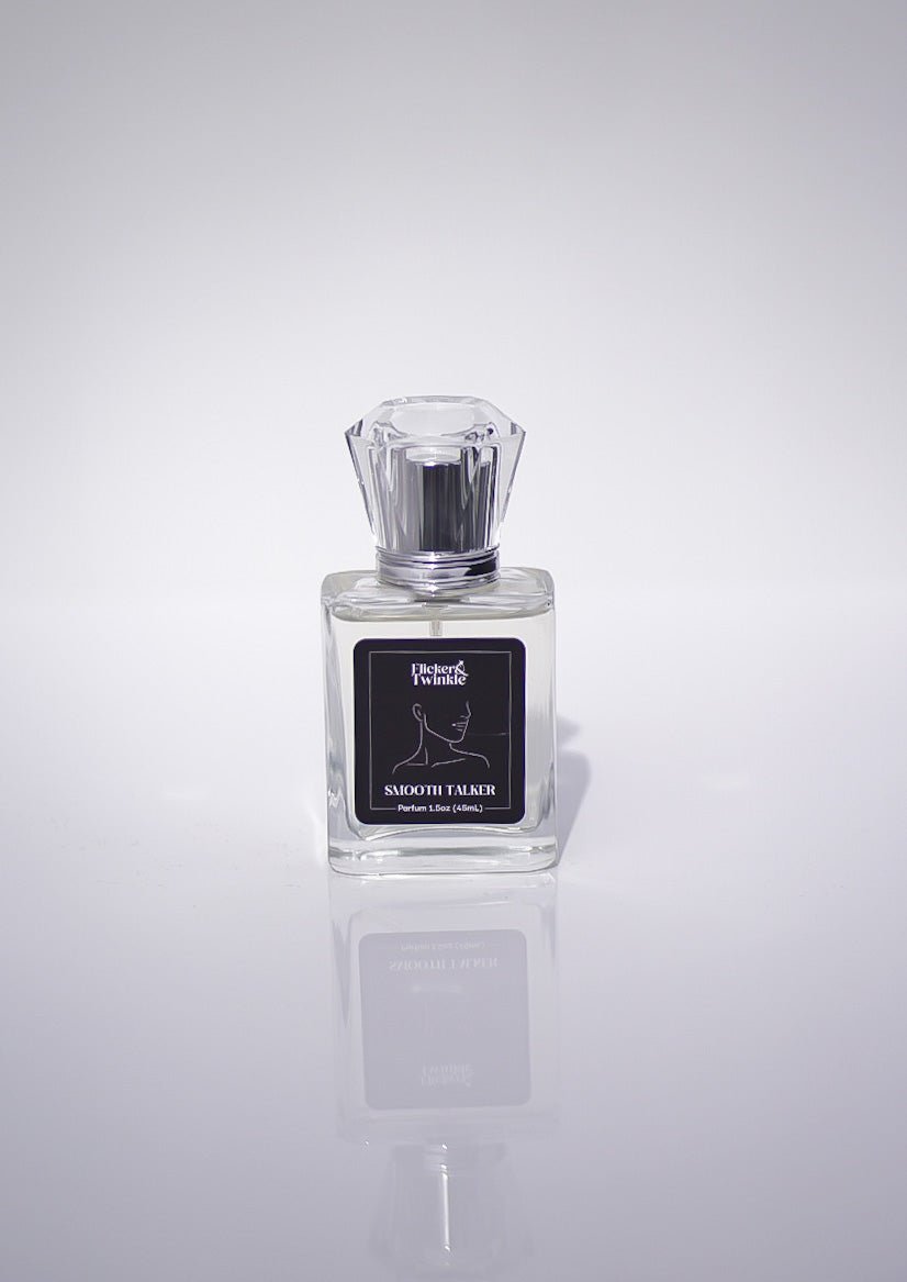 A clear glass bottle of Smooth Talker Parfum, a woody unisex scent, on a white background.