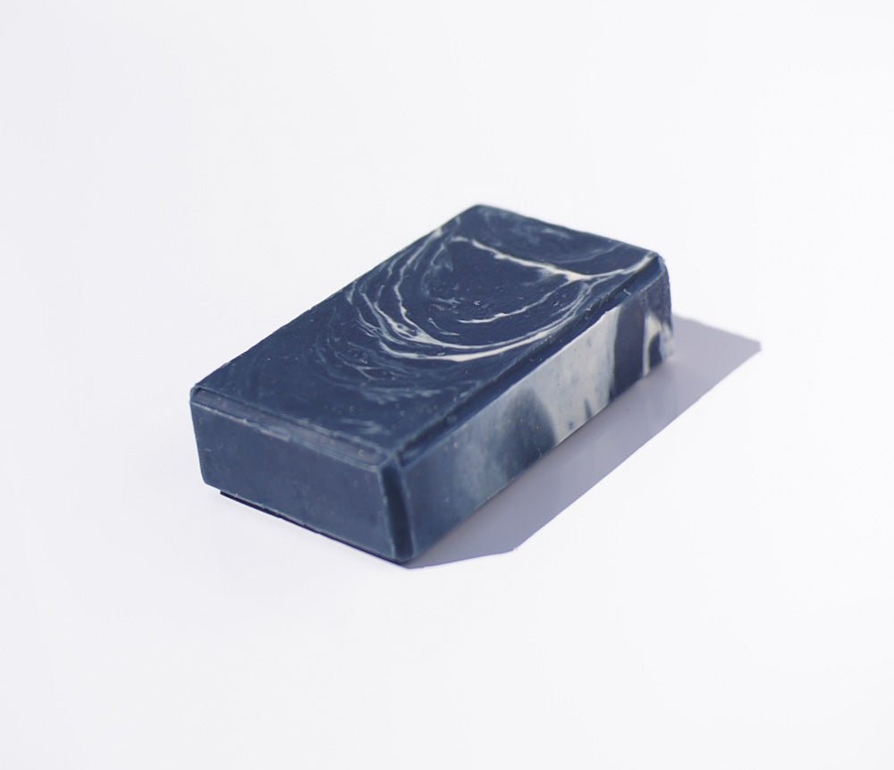 The Yachtsman Goat Milk Soap: rectangular, dark gray, ocean scent, on white background with shadow.