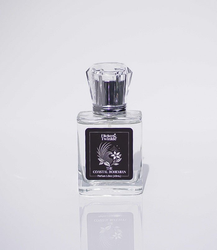 Clear glass bottle labeled The Coastal Bohemian Perfume, a luxury scent with boho coastal vibes.