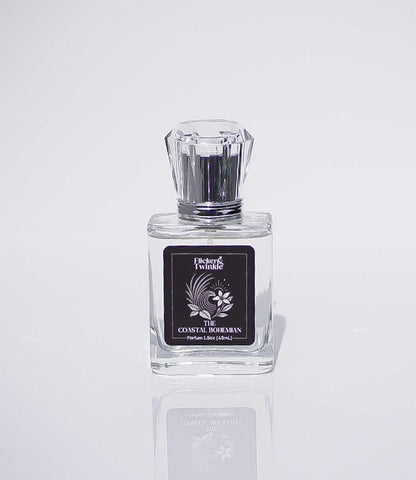 Clear glass bottle labeled The Coastal Bohemian Perfume, a luxury scent with boho coastal vibes.