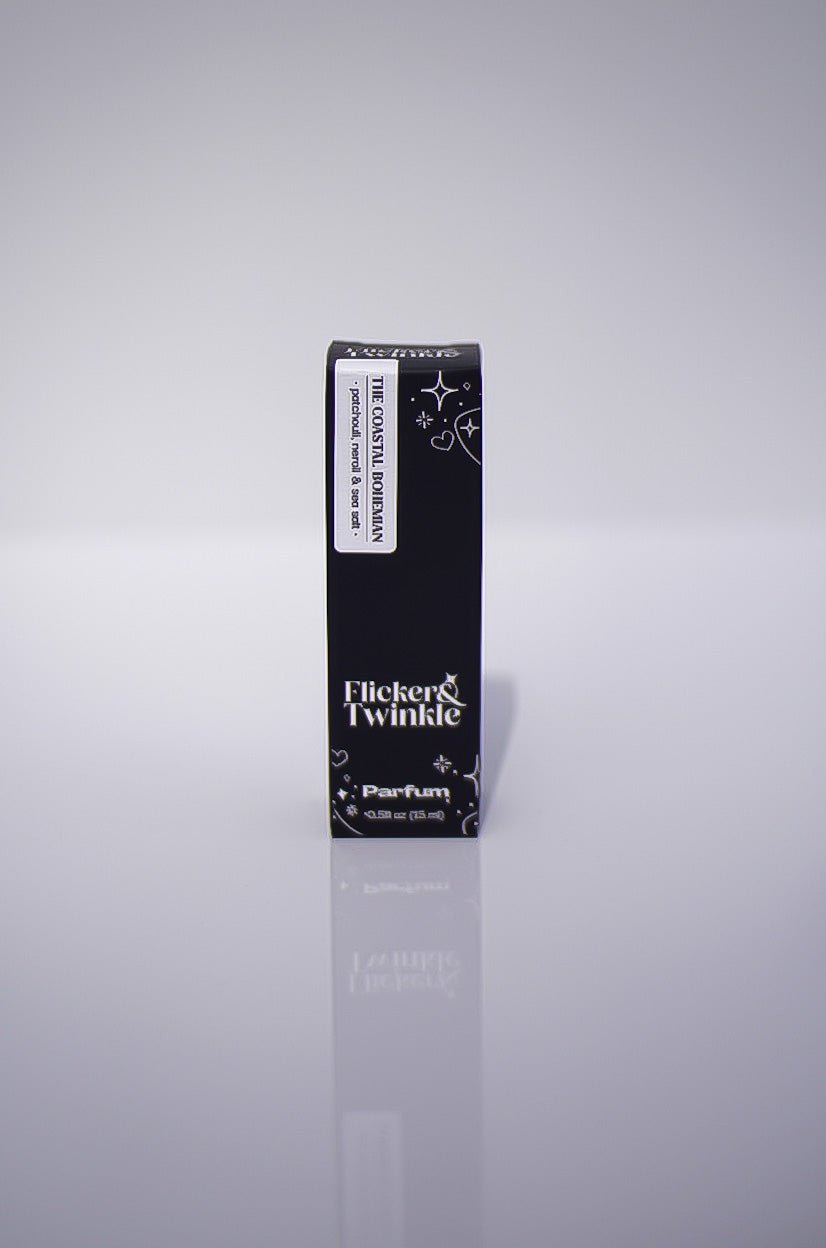 A black box labeled The Coastal Bohemian Perfume, a luxury scent, stands upright on white.