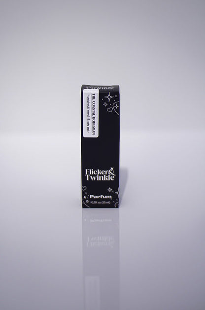 A black box labeled The Coastal Bohemian Perfume, a luxury scent, stands upright on white.