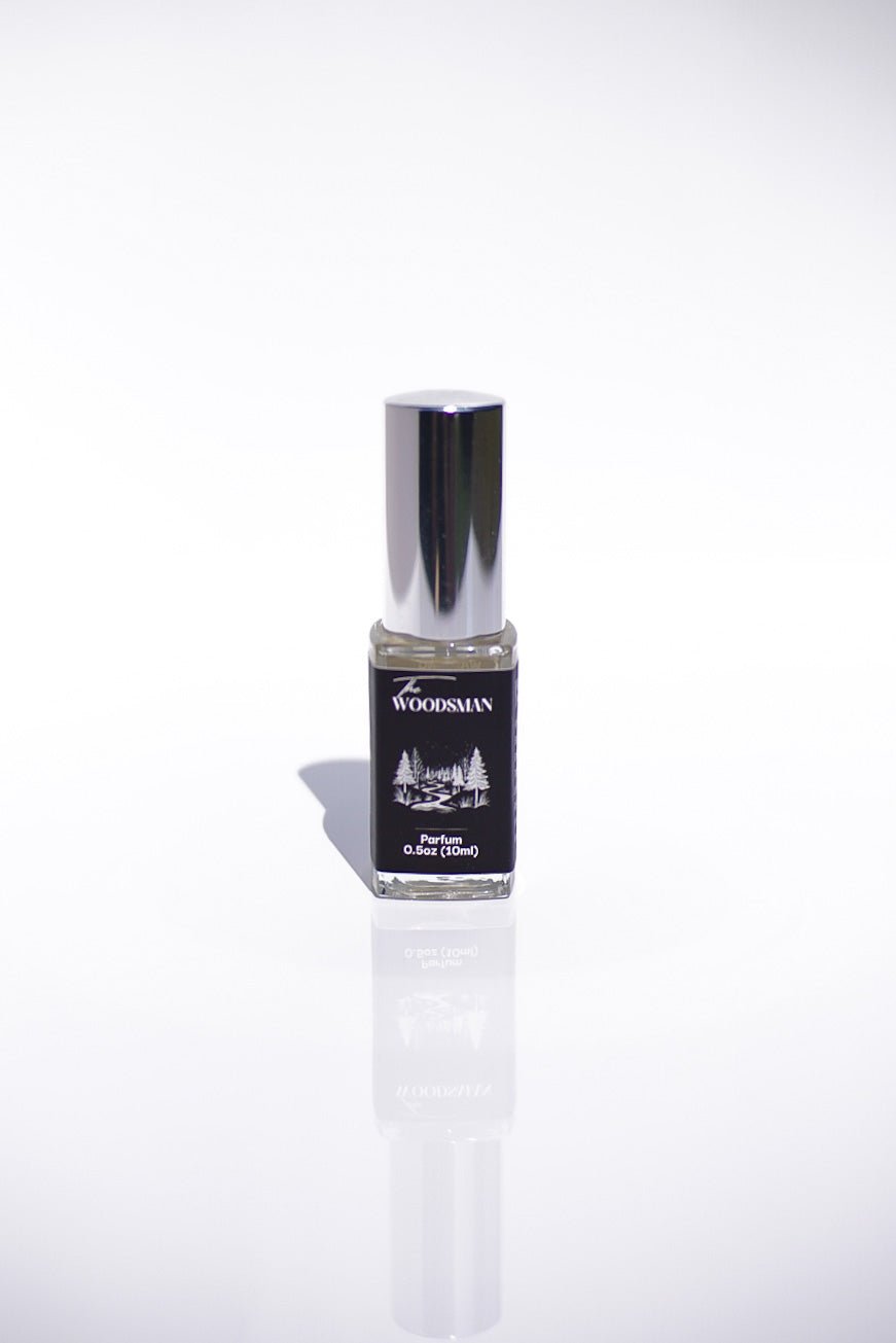The Woodsman Parfum with a silver cap on a white background.