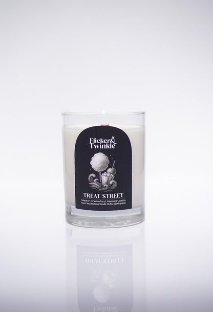 A luxury Treat Street Candle - Coconut Soy Beeswax in a glass jar with Flicker & Twinkle label.