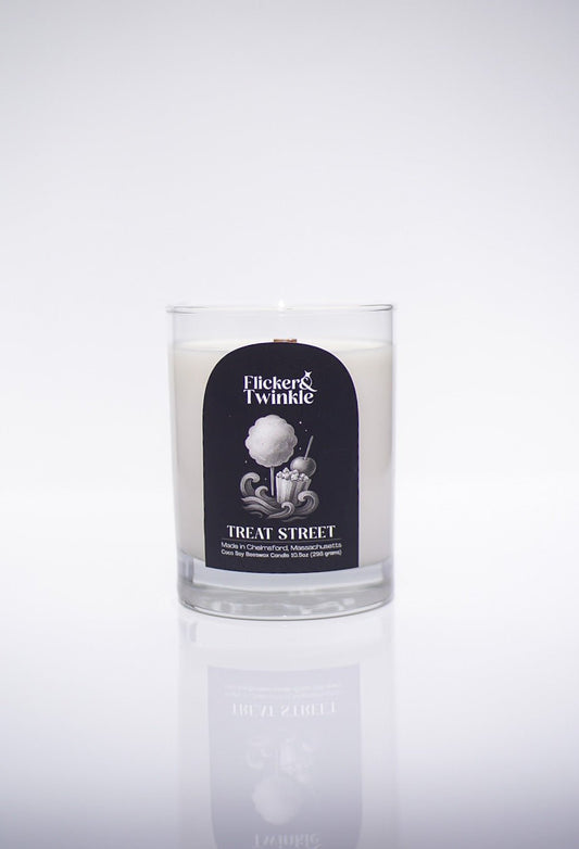 A luxury Treat Street Candle - Coconut Soy Beeswax in a glass jar with Flicker & Twinkle label.