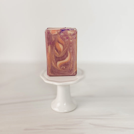 Bar Soap - Lavender Santal Goats Milk Soap- Cold processed soap on top of a white pedestal in front of a white blurred background