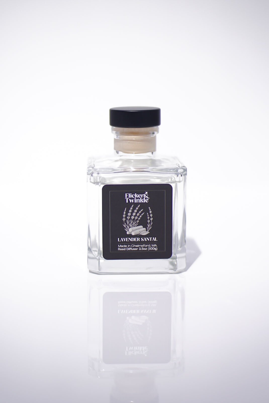 Lavender Santal Reed Diffuser shown in a square glass bottle with a black cap.