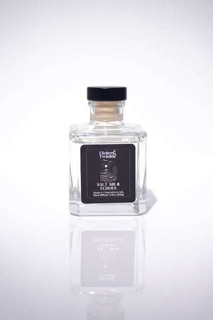 Salt Air & Echoes Reed Diffuser in a glass bottle with black label, on a white background.