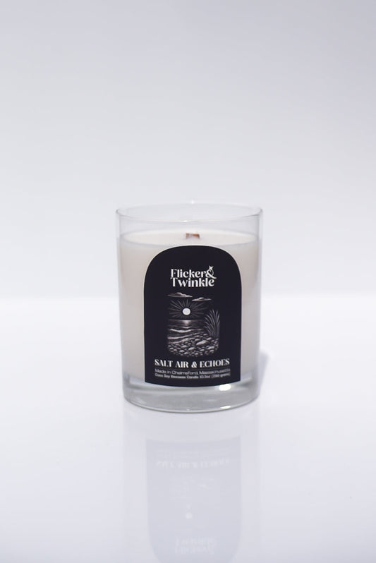 A white Salt Air & Echoes Candle in a glass jar, made with coconut soy beeswax.