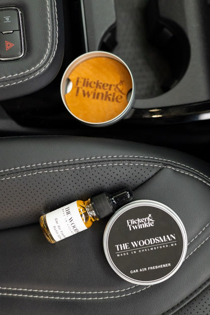 Flicker & Twinkle car air freshener with refill on a car dashboard
