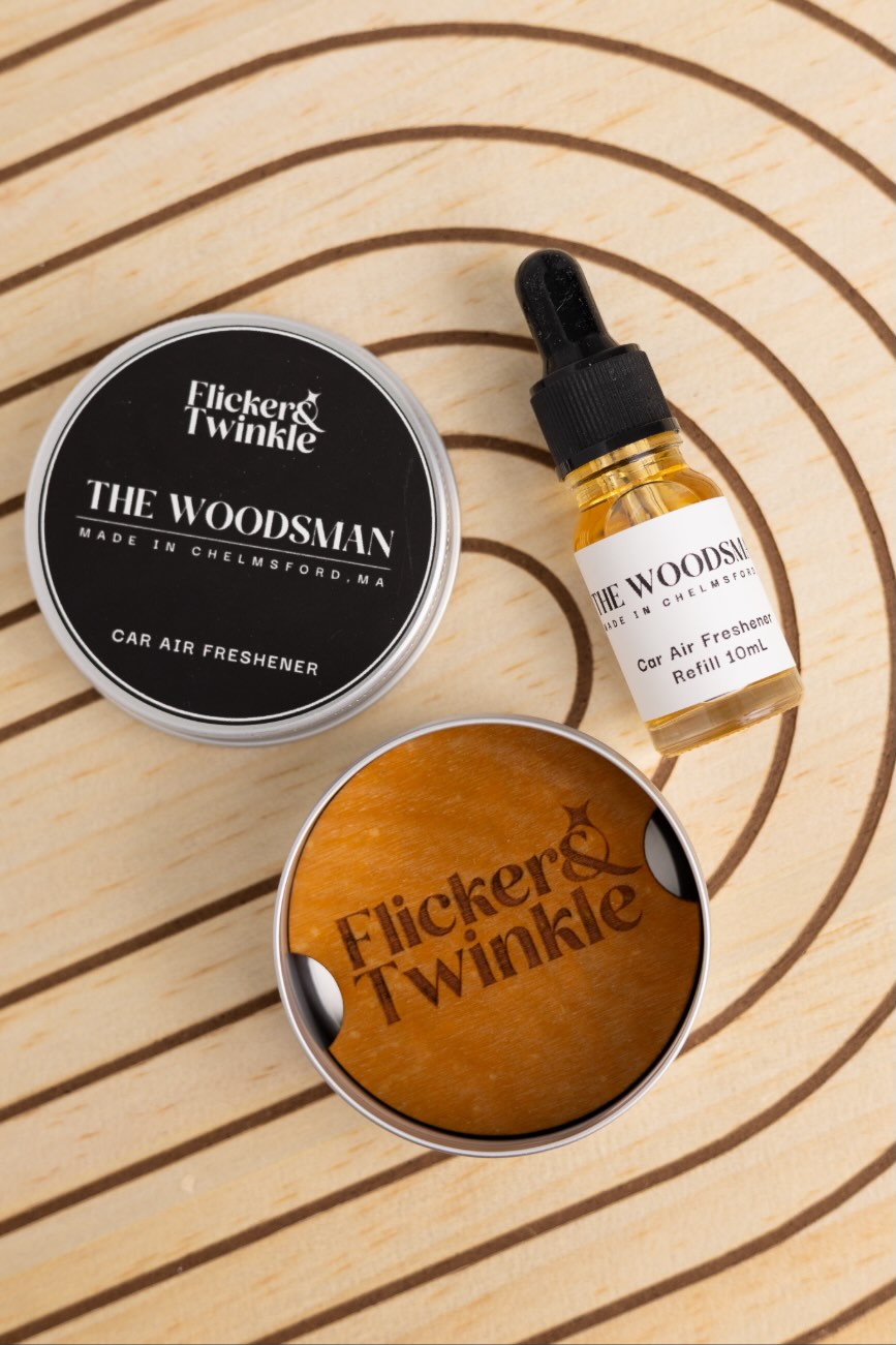 Flicker & Twinkle The Woodsman refillable car air freshener—engraved wood diffuser with 10 mL refill.